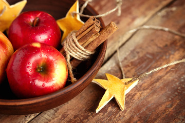 Red apples with cinnamon in a bowl