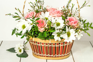 Basket with roses and chrysanthemums