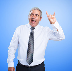 mature man doing a rock gesture