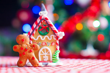 Cute gingerbread man and candy ginger house background Christmas tree lights