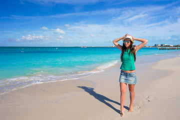 Fototapeta na wymiar Young beautiful woman on beach during tropical vacation