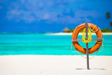 Lifebuoy on tropical white beach 