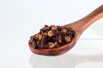 clove in spoon isolated on a white background
