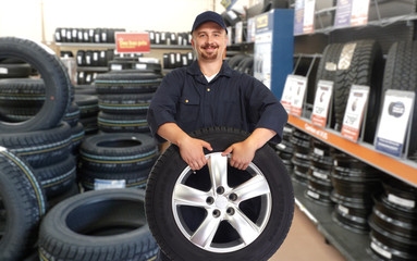 Car mechanic with a tire.