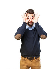 Fototapeta premium man doing a glasses sign