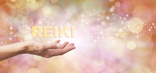 Golden Reiki Healing Energy Share    - Female with outstretched hand palm facing up and the word 'REIKI' hovering above  on an ethereal golden bokeh and sparkles background and white light - obrazy, fototapety, plakaty