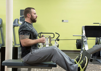 Man Using Seated Row Machine