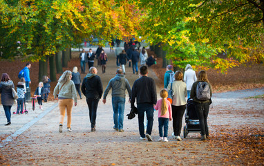 LONDON, UK - OCTOBER 31, 2015: Autumn in London park, people and families walking and enjoying the...