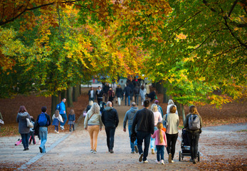 LONDON, UK - OCTOBER 31, 2015: Autumn in London park, people and families walking and enjoying the weather