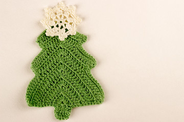 Christmas tree made from green knitted thread with a red star on