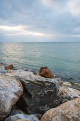 Fototapeta na wymiar Beach with rocks at sunset