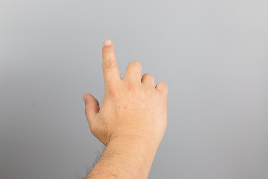 Man hand sign isolated on gray background