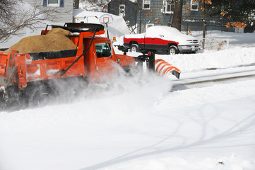 snowplow truck removing snow in the street