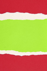 Ripped red paper on green background
