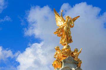 Golden Statue in London with dramatic sky background 