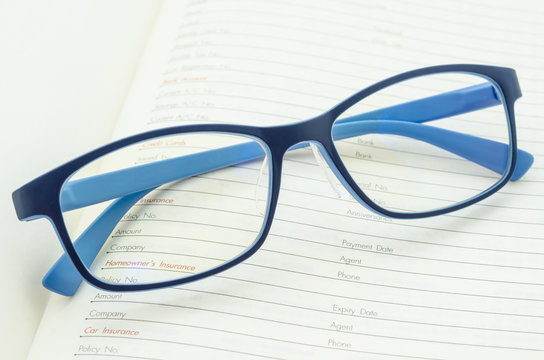 Eyeglasses on open diary planner.
