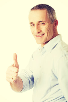 Mature man gesturing ok sign
