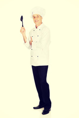 Chef holding black plastic spoon