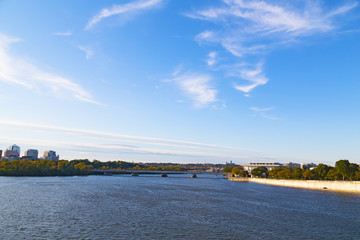 Washington DC panorama before the sunset. A view from Arlington memorial Bridge on Rosslyn skyscrapers, Kennedy Center, Georgetown waterfront and National Cathedral on the horizon.