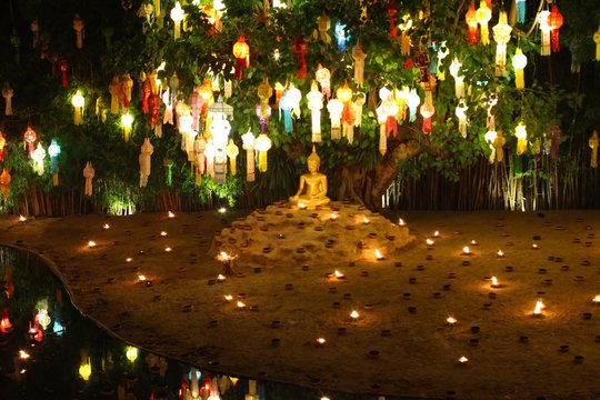  The Buddhist with small fire lamp  and paper lanterns formed in loykratong festival at Wat Phan Tao in Chiang Mai - Thailand