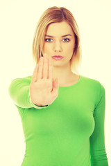 Young woman with stop gesture.