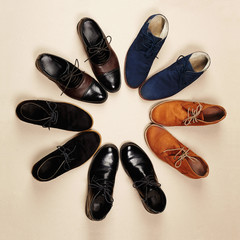 a lot of men's shoes.fashion still life men boots on paper background
