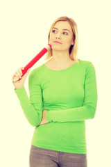 Thoughtful woman with big pencil.