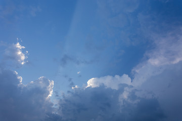 Fototapeta na wymiar sun beam in blue sky with clouds background