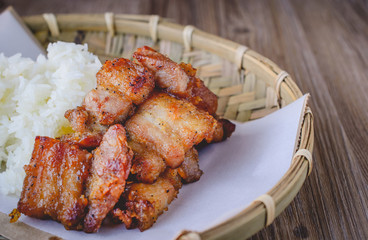 deep fried pork with sticky rice on wood basket, thai food, thai