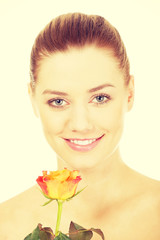 Fototapeta premium Smiling woman with fresh rose.
