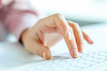 Woman office worker typing on the keyboard