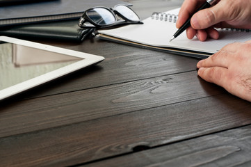Male hands writing in a notebook