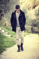 Fototapeta premium Handsome athletic young man hiking in park