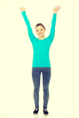 Young happy woman with hands up.