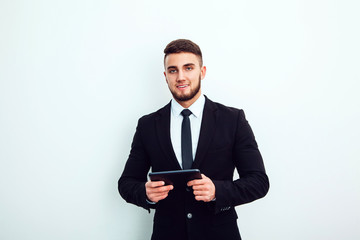 Portrait of an handsome businessman with a tablet