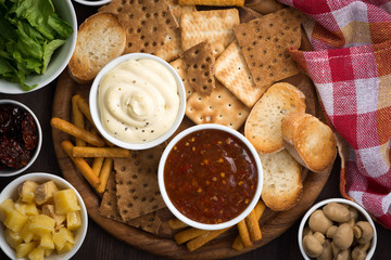assortment delicious appetizers with sauces, top view