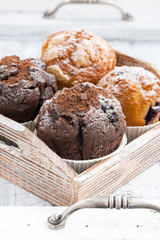 assortment of fresh delicious muffins, vertical
