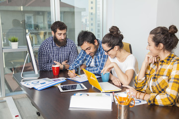 Business team working at a desk on computers.