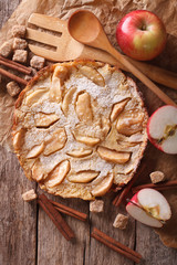 Fototapeta premium Dutch baby pancake with apple on a paper closeup. Vertical top view