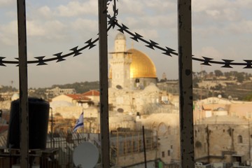 Close up of barbed wire with Temple Mount in background