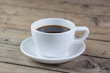 Obraz premium White cup of coffee on wood background