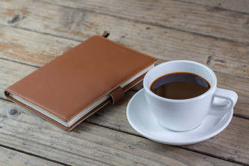 White cup of coffee on wood background