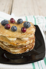 pancakes with banana, honey and blueberries for breakfast on a t