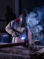 A welder welding a steel beam
