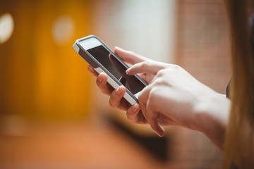 Standing student using smartphone