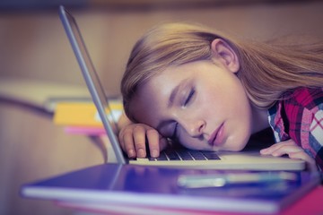 Blonde student sleeping on laptop