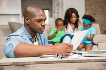 Concentrated father reading paper