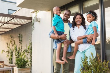 Happy african american family standing in the garden 