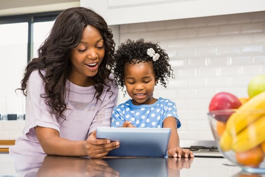 Mother and daughter using tablet pc 