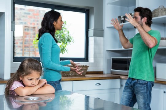 Sad Child Listening To Parents Argument